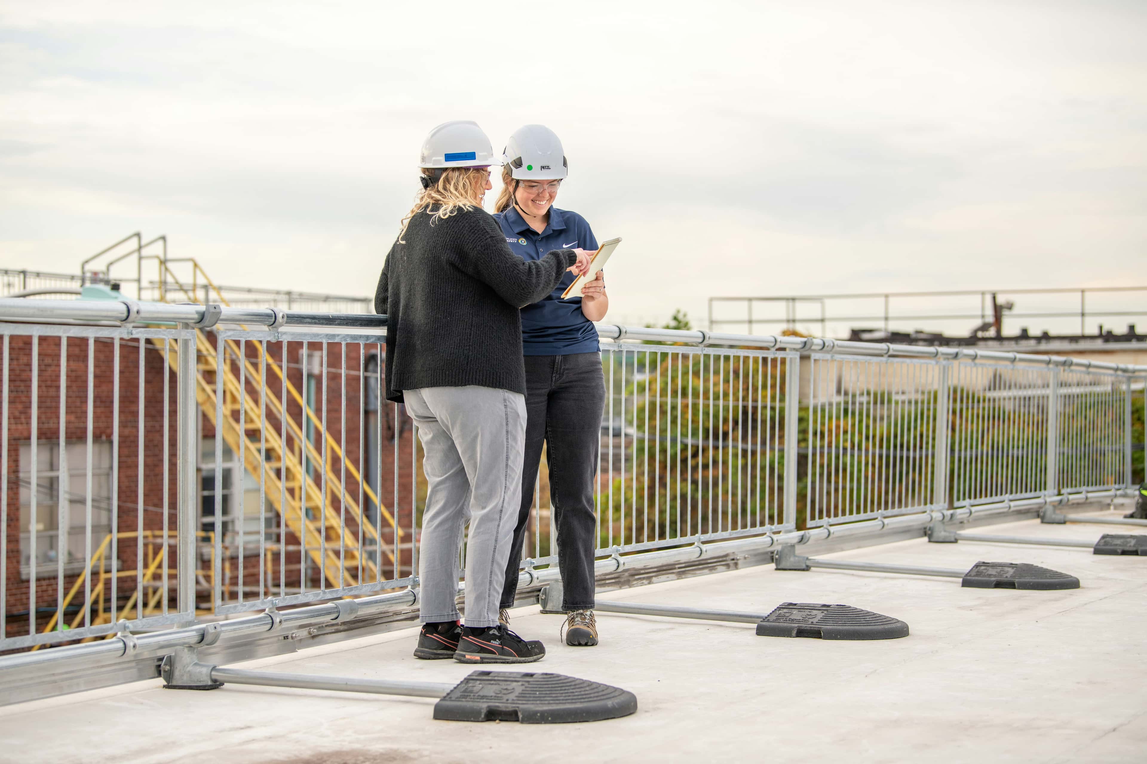 two people collaborating on a rooftop