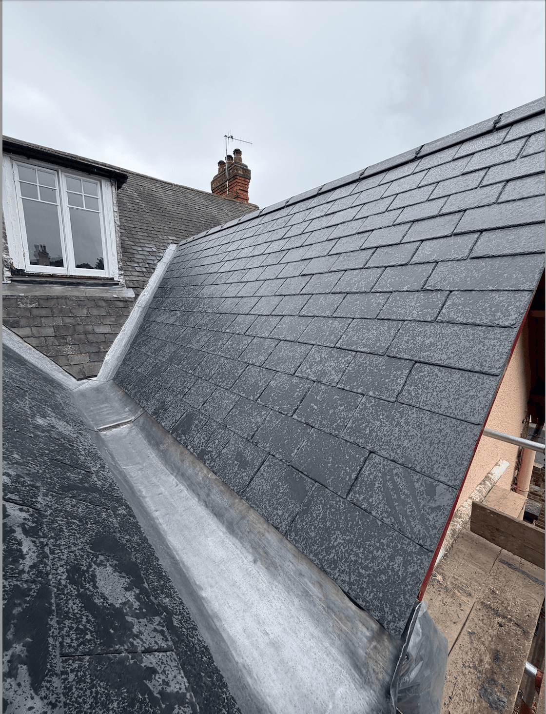 Newly slated extension roof with natural slate, photographed from scaffolding